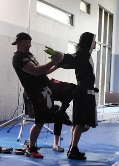 A boxer is prepped by his coach